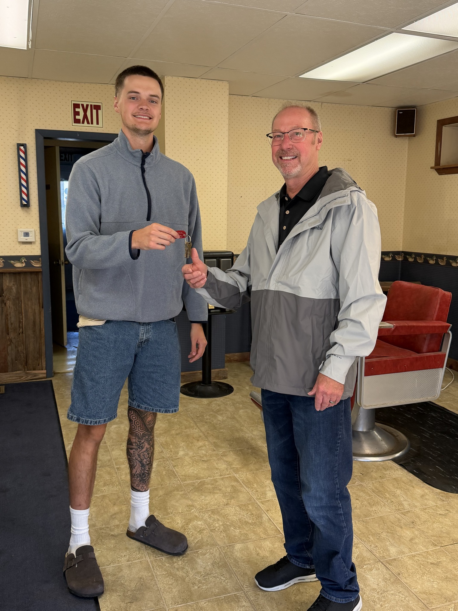 Barber Cole Davis with retiring owner Rick Hicks inside the Dimondale shop at 111 N Bridge St, soon to reopen as Cole Cutsss